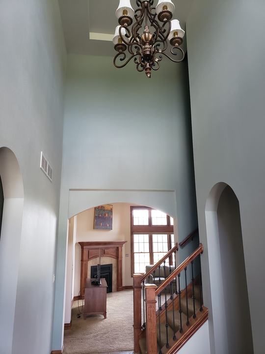 Two-story foyer with arched openings, walls and ceiling