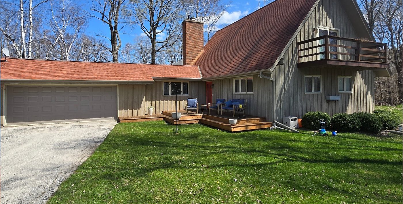 Before: weathered cedar siding